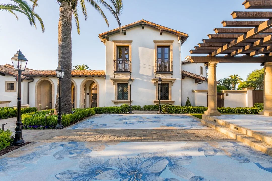 Paved courtyard and timber shade structure beside the home