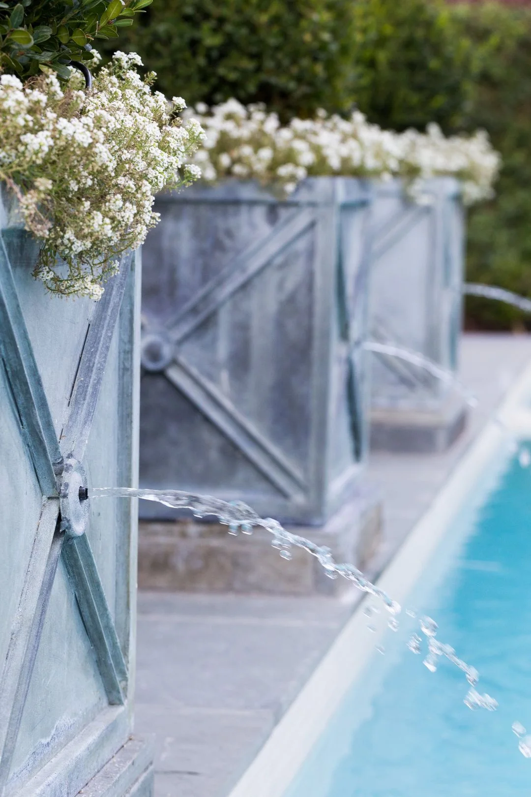 Close view of narrow water jets emerging from a decorative water wall