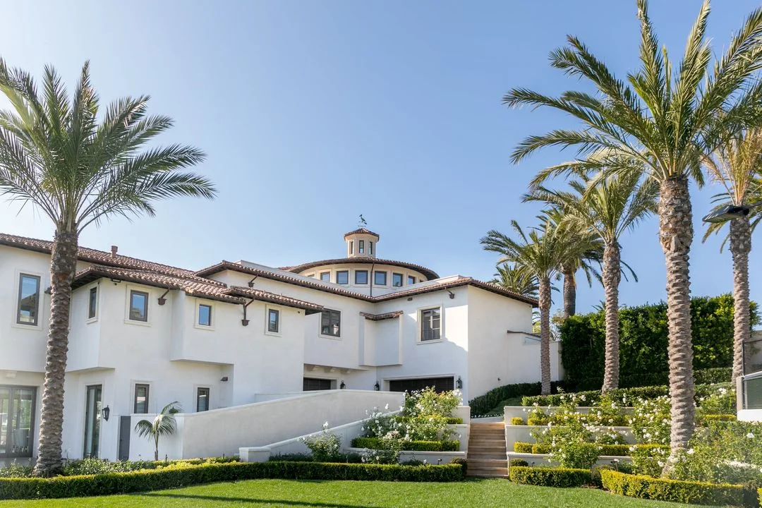 Palms and layered planting beside the estate home