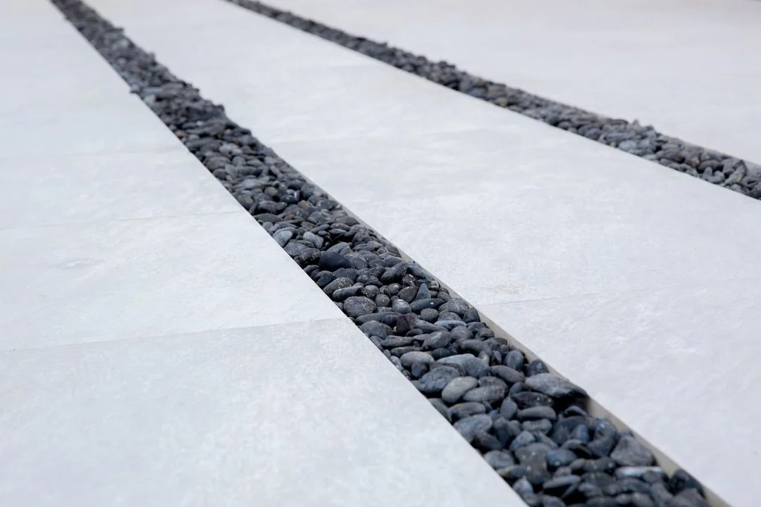 Broad pale stepping pads separated by dark gravel