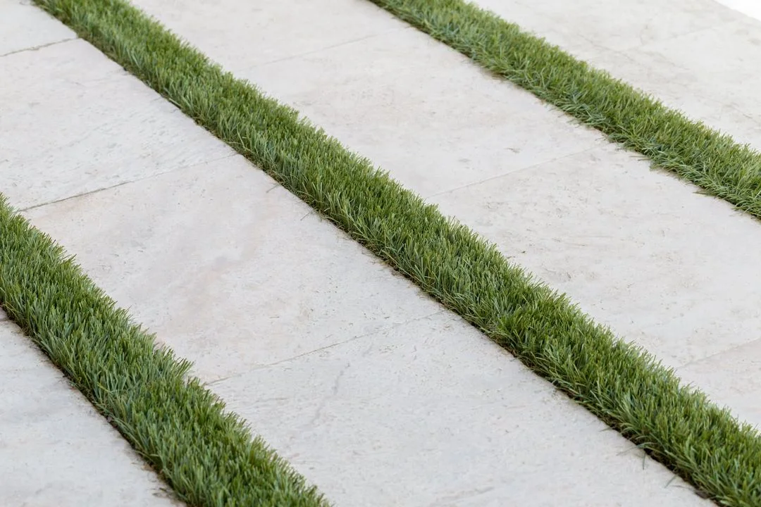 Broad paving pads separated by narrow lawn joints
