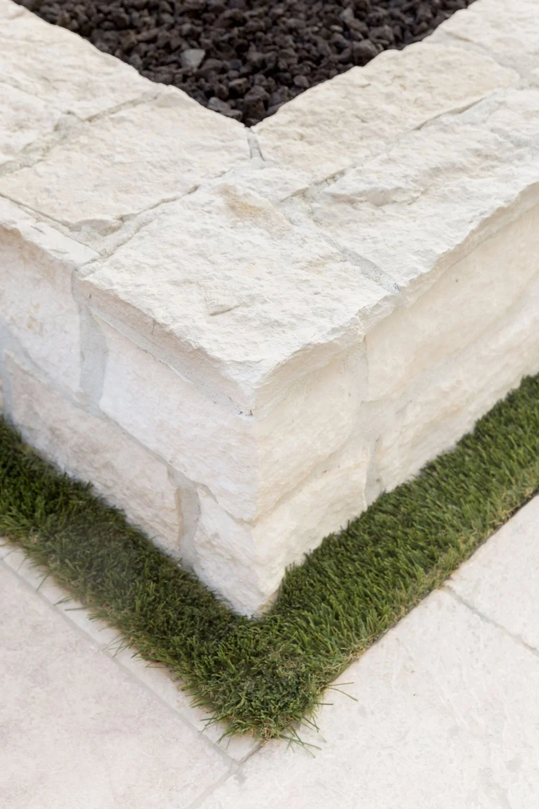 Close-up detail of pale textured stone masonry