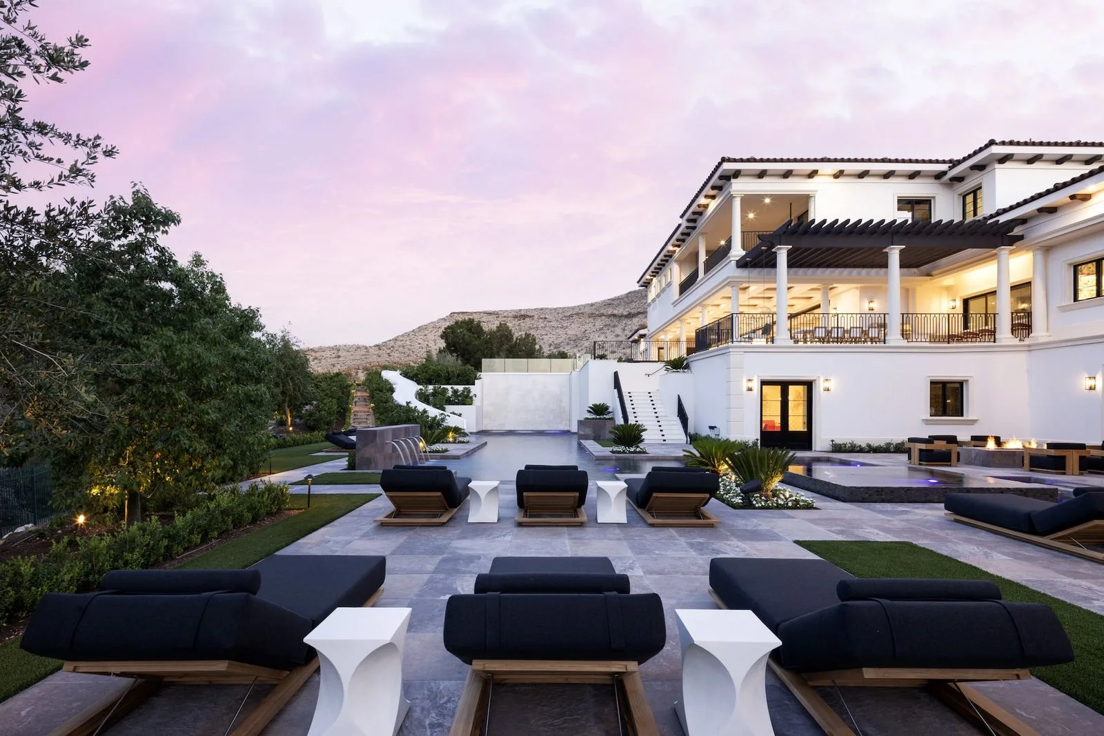 Terraced backyard with lounge seating, a pool and covered outdoor living areas