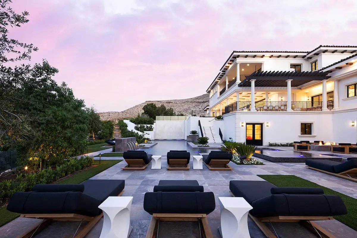 Terraced backyard with lounge seating, a pool and covered outdoor living areas